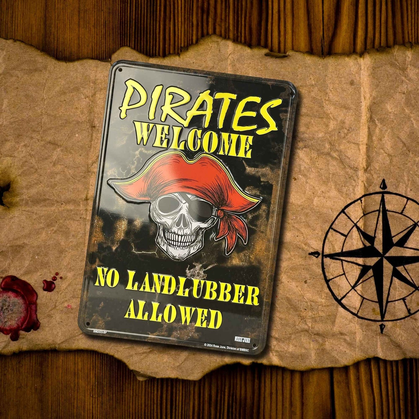 Pirate-themed metal sign with skull and red bandana on a textured surface with a compass.