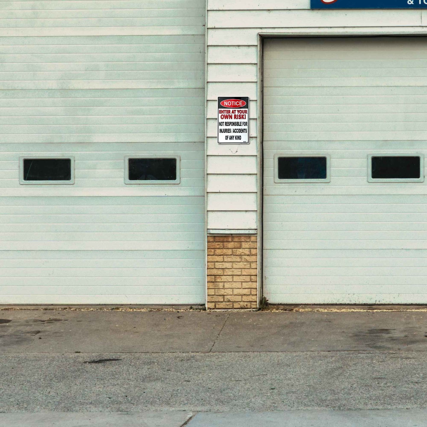 Two industrial garage doors on a building with a small wooden wall between them.