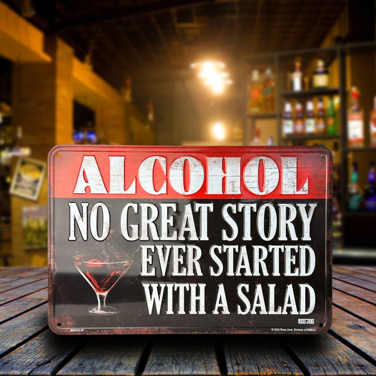 Metal sign with humorous alcohol quote on a bar counter