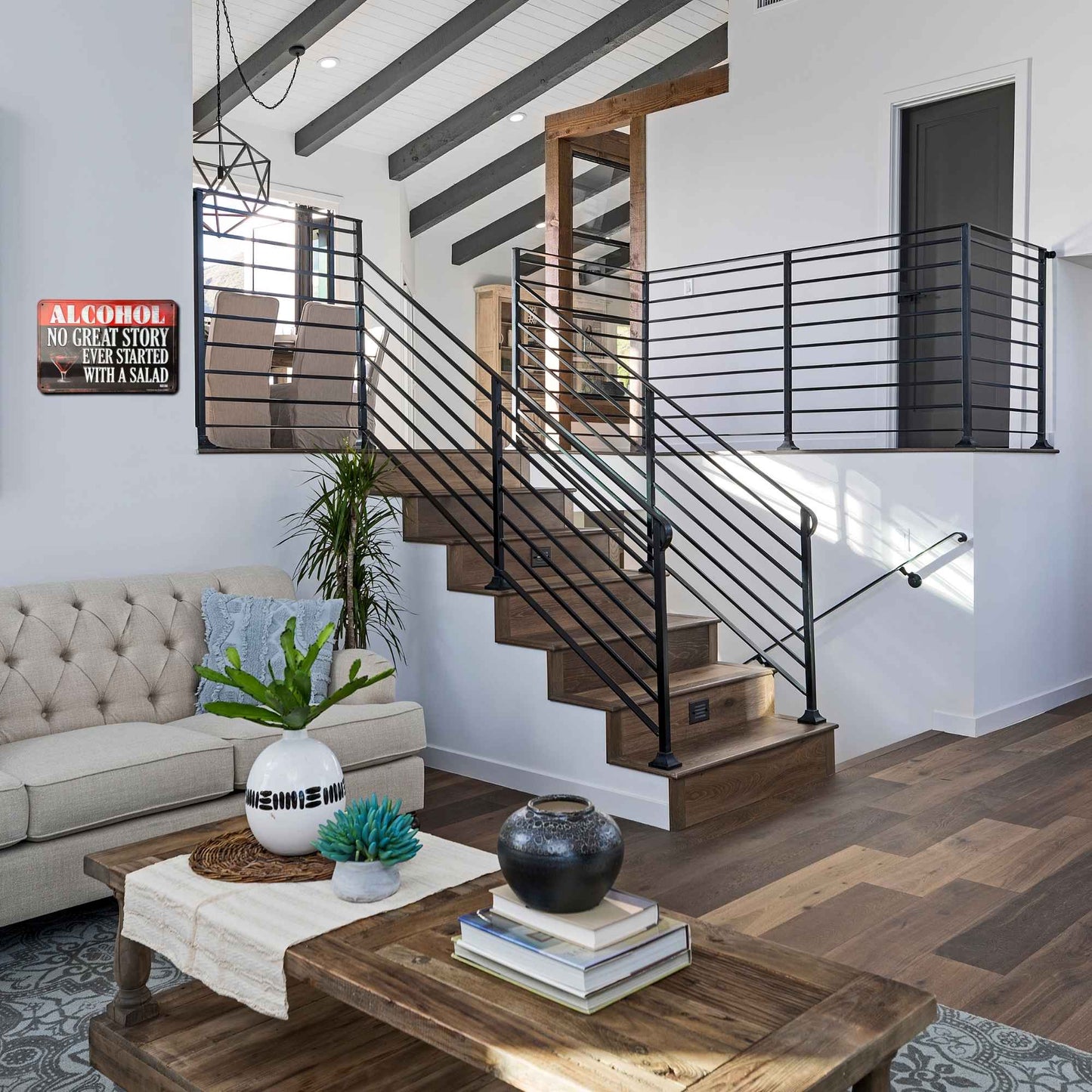 Modern living room with staircase, sofa, and coffee table.