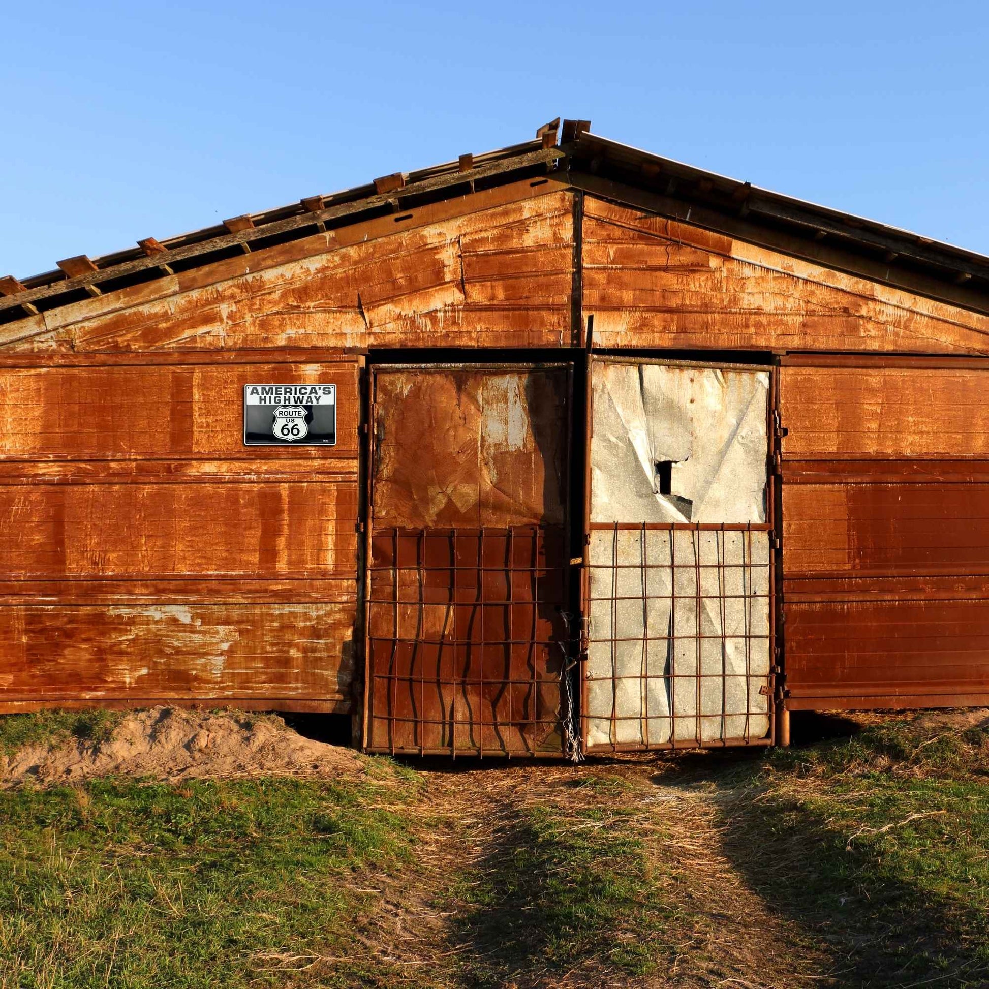 Rustic wooden building with a sign on a clear day