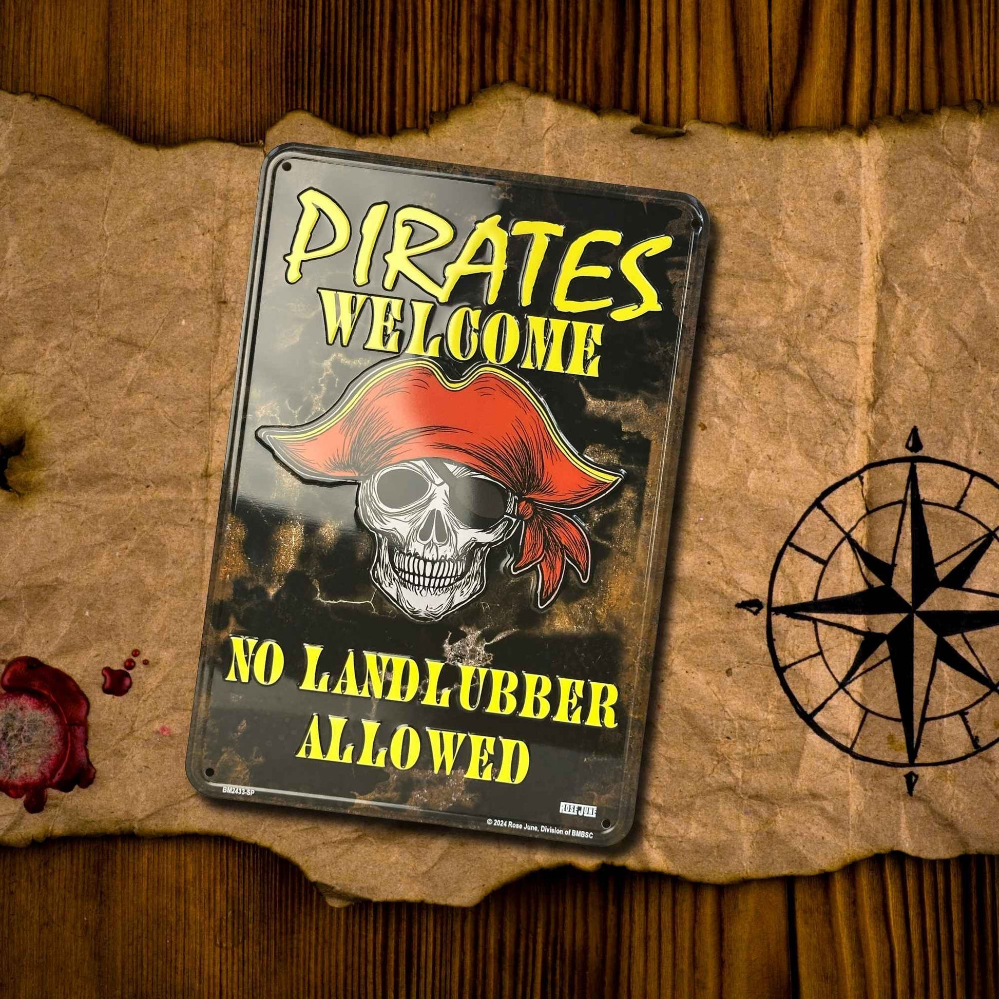 Pirate-themed metal sign with skull and red bandana on a textured surface with a compass.