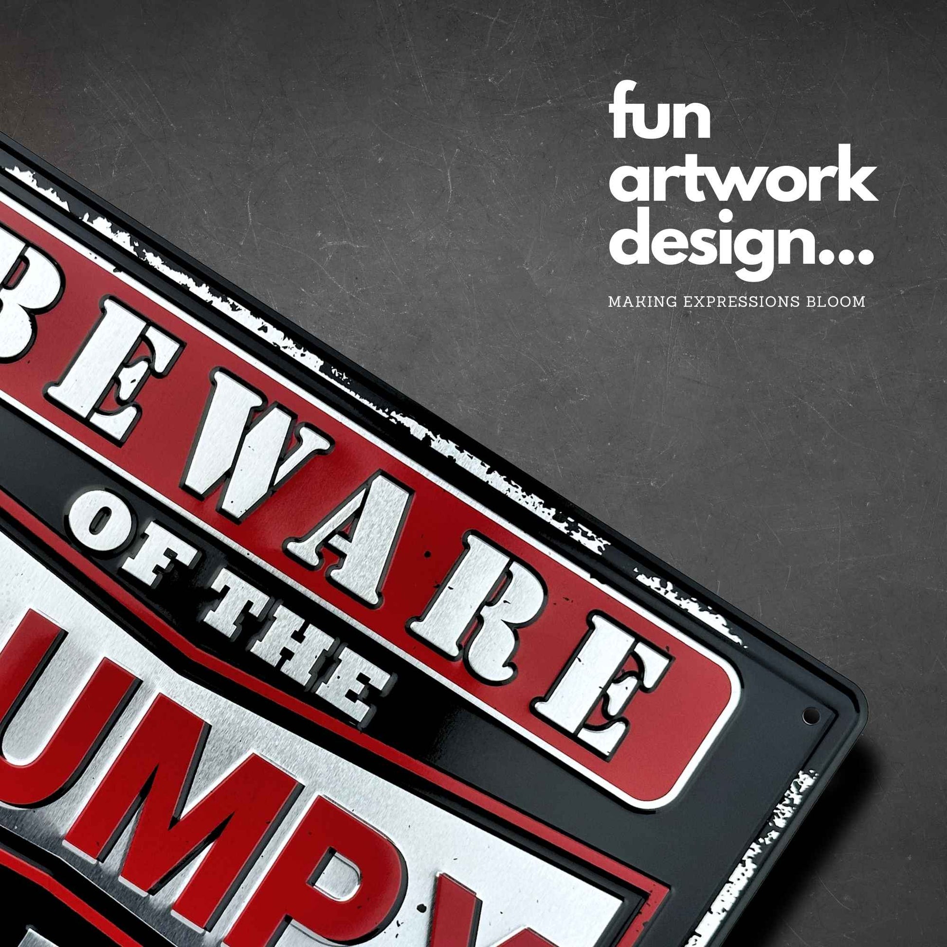 Metal sign with 'Beware of the Grumpy' text on a dark background